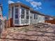 Rear view of home showing fenced backyard, windows, siding, and a corner bay window at 12948 E 106Th Way, Commerce City, CO 80022