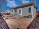 Backyard exterior featuring gray siding and a concrete patio with double glass doors at 12948 E 106Th Way, Commerce City, CO 80022
