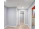 Finished basement hallway features wood floors and neutral paint at 12948 E 106Th Way, Commerce City, CO 80022