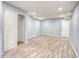 Finished basement with light gray walls, closet, white door and light wood flooring at 12948 E 106Th Way, Commerce City, CO 80022