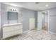 Bathroom featuring a double sink vanity and large mirror at 12948 E 106Th Way, Commerce City, CO 80022