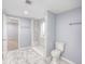 Updated bathroom featuring a spacious shower, new toilet and marble-look tile flooring at 12948 E 106Th Way, Commerce City, CO 80022