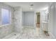 Updated bathroom with marble-look shower, double vanity, and tile floor at 12948 E 106Th Way, Commerce City, CO 80022