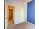 Bedroom with blue accent wall and doorways to other rooms at 12948 E 106Th Way, Commerce City, CO 80022