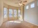 Bright bedroom with large windows, ceiling fan, and neutral carpet at 12948 E 106Th Way, Commerce City, CO 80022