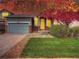 Charming home with a well-manicured lawn, brick accents, and a two-car garage at 12948 E 106Th Way, Commerce City, CO 80022