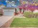 Charming home featuring a well-kept front yard and covered porch with brick columns and a two-car garage at 12948 E 106Th Way, Commerce City, CO 80022