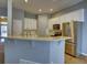 Bright kitchen features granite countertops, a breakfast bar, and stainless steel refrigerator at 12948 E 106Th Way, Commerce City, CO 80022