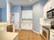 Bright kitchen featuring white cabinetry, modern appliances, and a tile floor at 12948 E 106Th Way, Commerce City, CO 80022