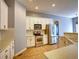 Well-lit kitchen with stainless steel appliances, tile floors, and white cabinetry at 12948 E 106Th Way, Commerce City, CO 80022