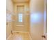 Bright laundry room featuring shelving, tile flooring, and a window at 12948 E 106Th Way, Commerce City, CO 80022