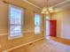 Inviting living room features carpet, natural light, and a red entry door at 12948 E 106Th Way, Commerce City, CO 80022