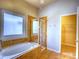 Main bathroom with tub, separate shower, window, and walk in closet access at 12948 E 106Th Way, Commerce City, CO 80022