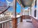 Relaxing front porch with brick pillars and a serene neighborhood view at 12948 E 106Th Way, Commerce City, CO 80022