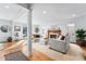 Spacious living room with a fireplace, recessed lighting, hardwood floors, and bright, natural light at 5977 S Zenobia Ct, Littleton, CO 80123