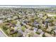 Aerial view of a neighborhood showcasing winding streets and mature trees near a lake at 8512 W Star Cir, Littleton, CO 80128