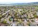 Bird's-eye view of the neighborhood with lush greenery, streets, and distant mountains at 8512 W Star Cir, Littleton, CO 80128