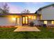 An inviting backyard with a well-maintained lawn and the home's exterior at sunset at 8512 W Star Cir, Littleton, CO 80128