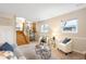 Cozy finished basement with ample seating, natural light, and neutral decor at 8512 W Star Cir, Littleton, CO 80128