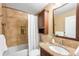 Stylish bathroom with a granite vanity, tiled shower-tub, and decorative niches for a relaxing experience at 8512 W Star Cir, Littleton, CO 80128