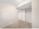 A carpeted bedroom with natural light let in through a window and a doorway leading to another room at 8512 W Star Cir, Littleton, CO 80128