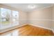 Bright bedroom features a hardwood floor, large windows, and neutral walls with natural light at 8512 W Star Cir, Littleton, CO 80128