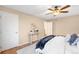 Bright bedroom featuring a hardwood floors, an accent wall, and a cozy queen-size bed with natural light at 8512 W Star Cir, Littleton, CO 80128