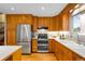 Well-lit kitchen featuring wooden cabinets and stainless steel appliances at 8512 W Star Cir, Littleton, CO 80128