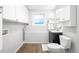 Bright laundry room features modern appliances, a sleek vanity, and ample storage for convenience at 8512 W Star Cir, Littleton, CO 80128