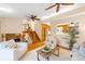 Open-concept living space featuring a fireplace and staircase at 8512 W Star Cir, Littleton, CO 80128