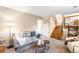 Relaxing living room space with plush carpet, neutral walls, and bright stairs to another level at 8512 W Star Cir, Littleton, CO 80128