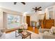 Bright living room with large windows, hardwood floors, and a comfortable seating arrangement at 8512 W Star Cir, Littleton, CO 80128