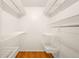 Large walk-in closet features custom shelving and hanging racks to keep all of your belongings organized at 8512 W Star Cir, Littleton, CO 80128