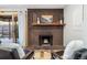 Living room with brick fireplace with rustic wood mantel and curated decor, creating a warm and inviting space at 2227 Canyon Blvd # 162B, Boulder, CO 80302