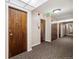 Well-lit hallway featuring neutral walls, patterned carpet, and doors to units at 2227 Canyon Blvd # 162B, Boulder, CO 80302