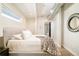 Cozy bedroom features a plush bed with white linens and hardwood flooring, plus a bathroom view at 3198 Blake St # 502, Denver, CO 80205