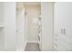 A spacious walk-in closet equipped with built-in shelving, and a stacked washer and dryer unit at 3198 Blake St # 502, Denver, CO 80205