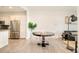 Dining room featuring a round table and modern chairs adjacent to the kitchen at 3198 Blake St # 502, Denver, CO 80205