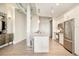 Open kitchen with a large island, stainless steel appliances, and sleek finishes at 3198 Blake St # 502, Denver, CO 80205