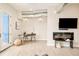 Bright living room with a modern fireplace, mounted television, and adjacent office space at 3198 Blake St # 502, Denver, CO 80205