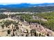An aerial view shows the home nestled in a vast area of Colorado mountain forest at 548 Coughlin Meadows Rd, Boulder, CO 80302