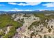 Expansive aerial view of a secluded red home with outbuilding on acreage with stunning mountain views at 548 Coughlin Meadows Rd, Boulder, CO 80302