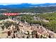 An aerial view shows the property and the vast area of Colorado mountain forest it resides in at 548 Coughlin Meadows Rd, Boulder, CO 80302