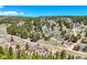 Secluded red home with outbuilding nestled on a hillside with trees at 548 Coughlin Meadows Rd, Boulder, CO 80302