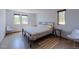 Brightly lit bedroom with simple metal frame bed and views to the trees outside at 548 Coughlin Meadows Rd, Boulder, CO 80302