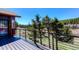 Spacious outdoor deck with black metal railings and stunning treetop views at 548 Coughlin Meadows Rd, Boulder, CO 80302