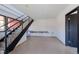 Bright hallway with a black metal staircase, white walls, and access to other rooms at 548 Coughlin Meadows Rd, Boulder, CO 80302