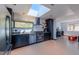 Modern kitchen with stainless steel appliances, granite countertops, and bright skylight at 548 Coughlin Meadows Rd, Boulder, CO 80302