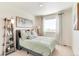 Inviting bedroom with a plush bed, stylish decor, and a window offering natural light and a serene view at 22315 E 6Th Ave, Aurora, CO 80018