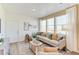 Comfortable living room bathed in natural light from large windows, featuring a plush sectional sofa at 22315 E 6Th Ave, Aurora, CO 80018